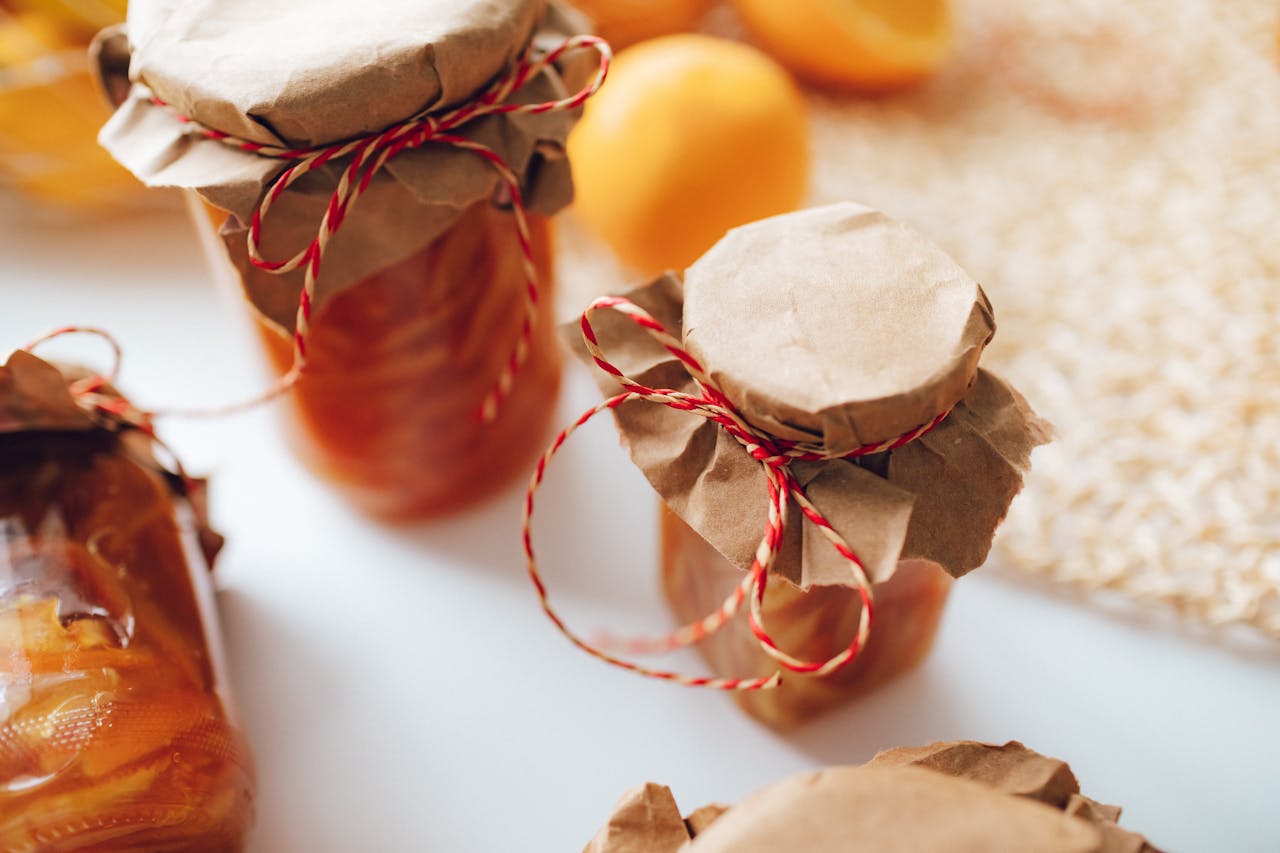 Crafting Captivating Headlines: Your awesome post title goes here A close-up image of homemade preserves in jars wrapped with paper and string, indoors.
